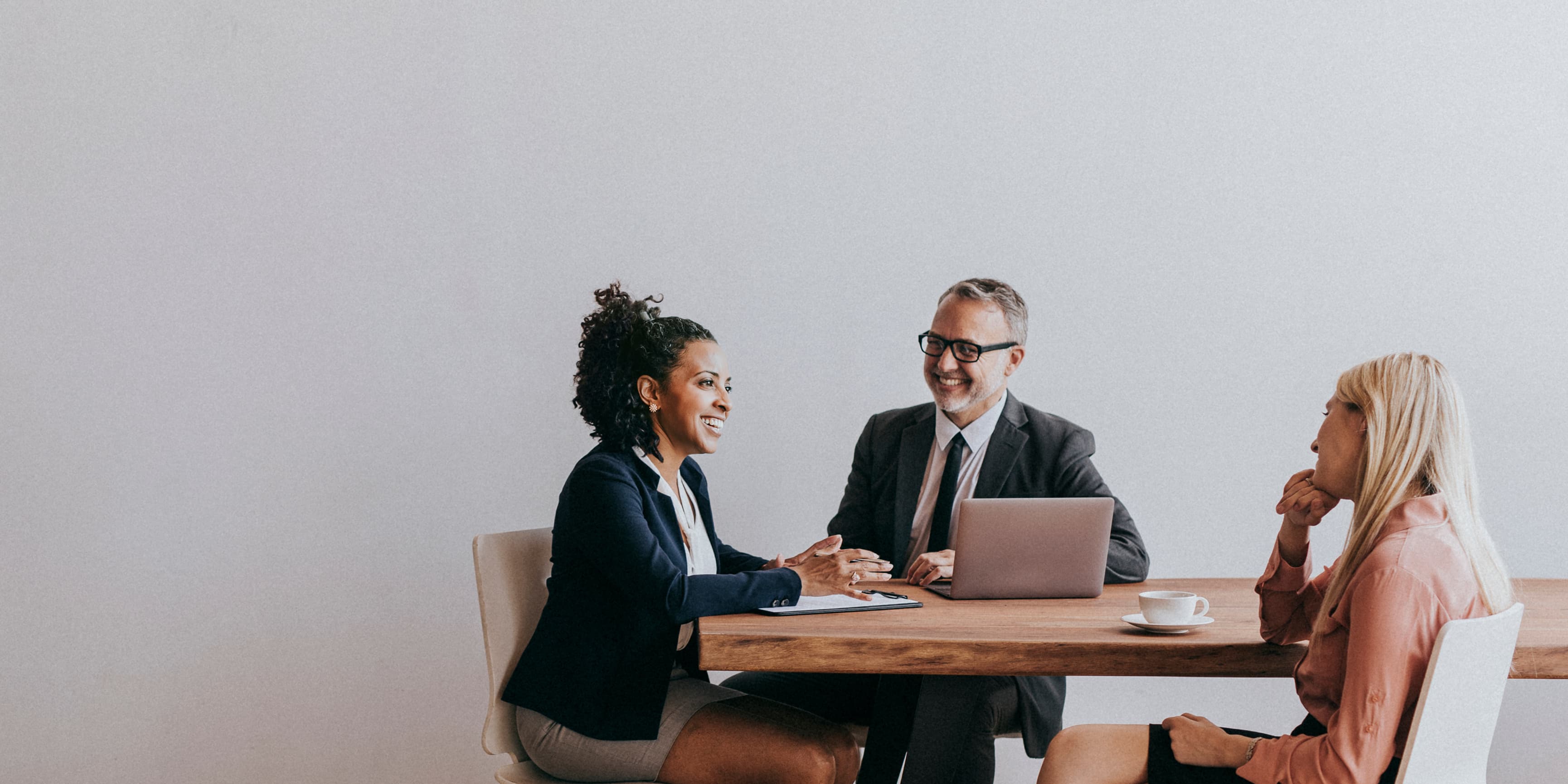 Picture of several colleagues discussing around a table.